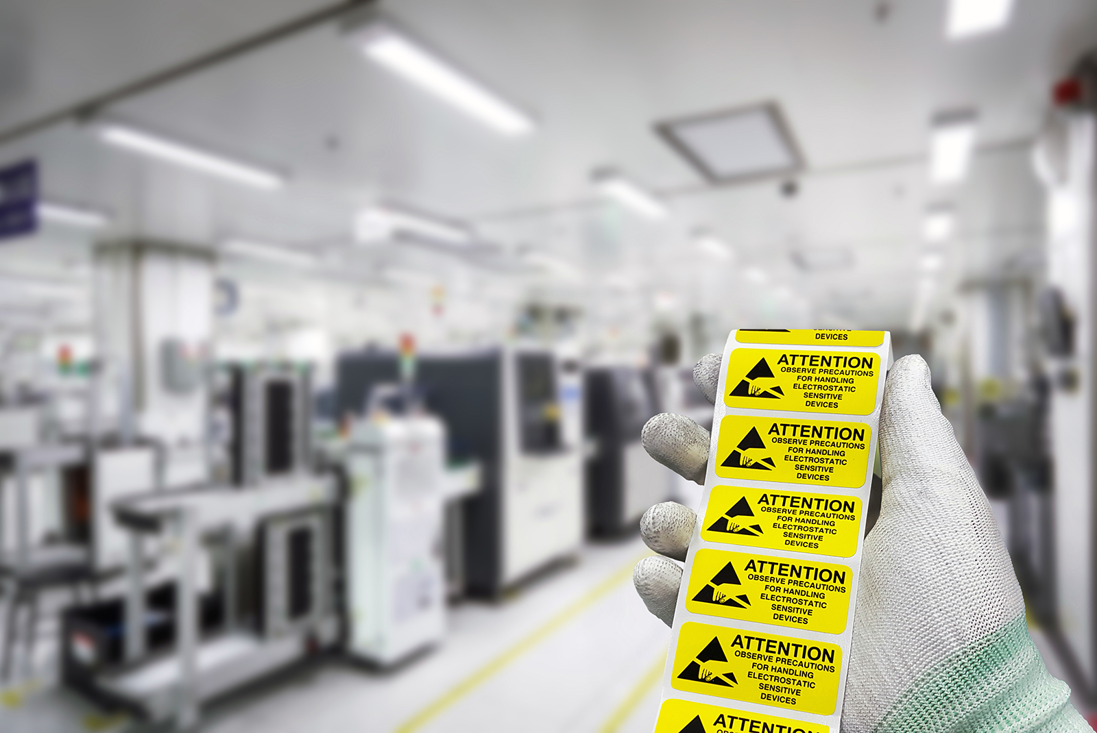 ESD stickers in a gloved hand on the manufacturing floor